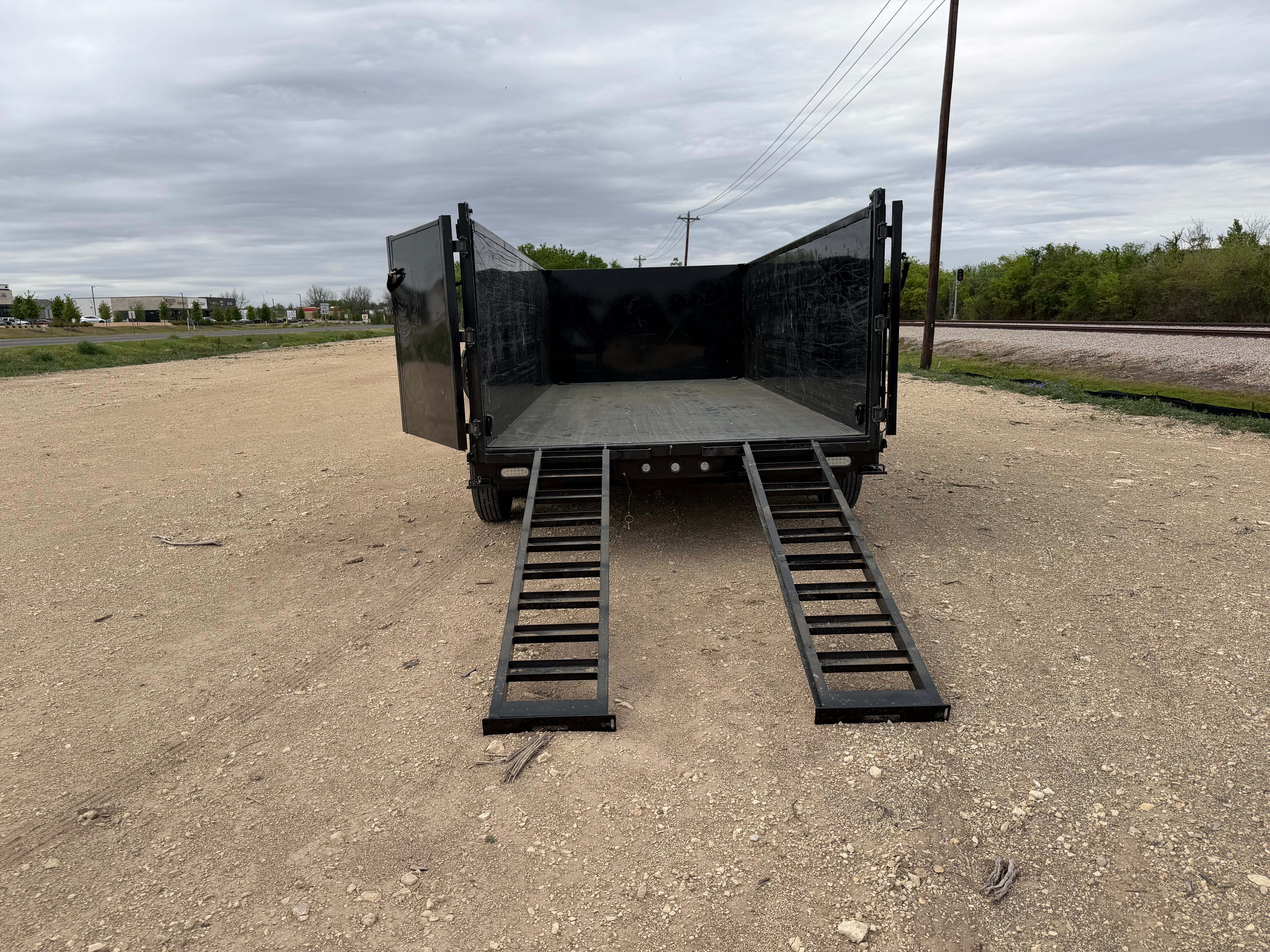 Maxx-D dump trailer straight rear view both ramps deployed